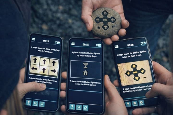 Players connecting their phones and sharing puzzle clues in the Sato Code multiplayer escape game